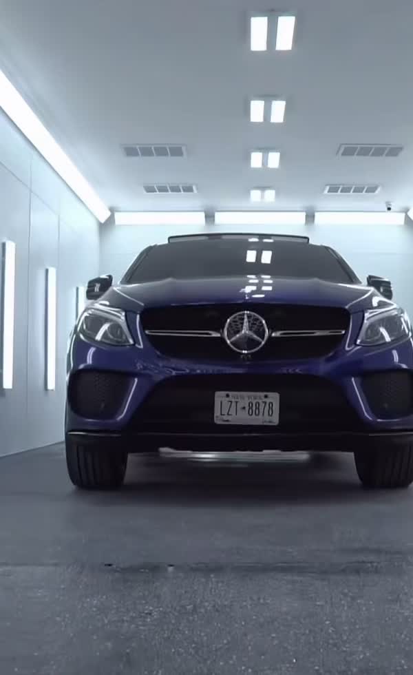 Blue Mercedes SUV inside the ENY Automotive paint booth